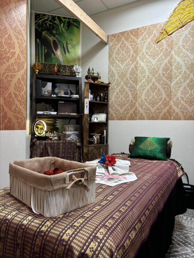 A bedroom with a bed, dresser and shelves.